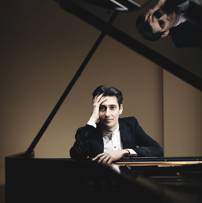 Yevgeny Sudbin sat at a large black piano