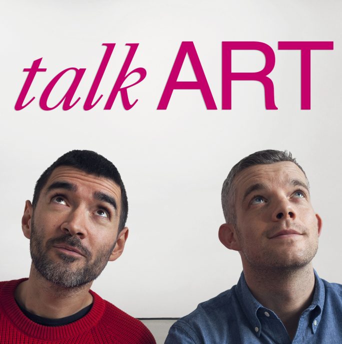 two men looking up at the words talk art